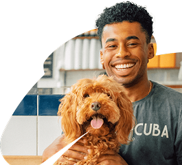 Man smiling with dog sticking out tongue