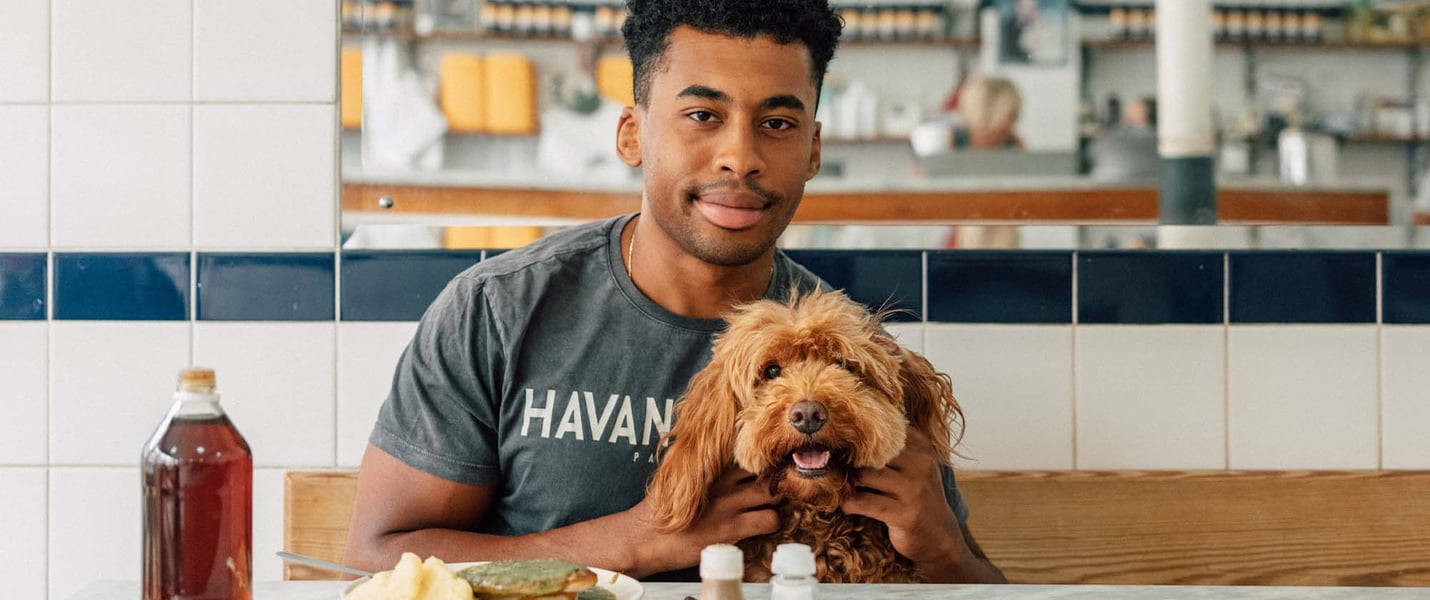 A man and his dog in a pie shop