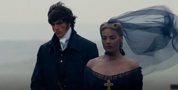 A still from Wuthering Heights film depicting Cathy and Heathcliff stood together.