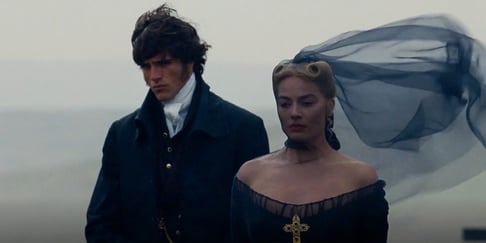 A still from Wuthering Heights film depicting Cathy and Heathcliff stood together.