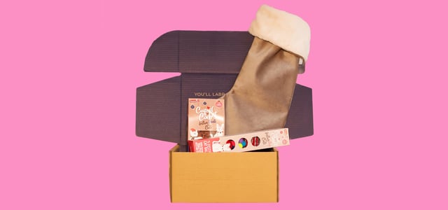 A stocking gift set on a pink background.