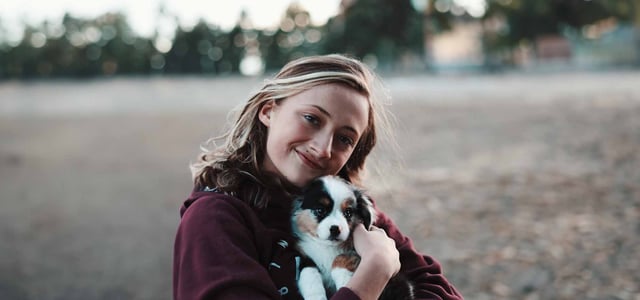 a woman hugging her puppy