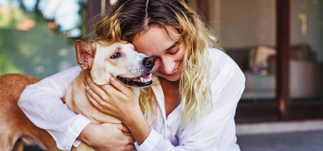 woman holding dog