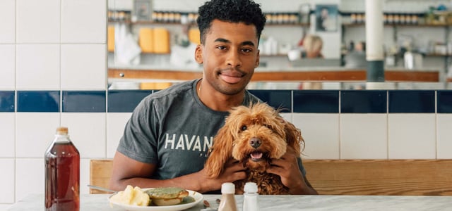 A man and his dog in a pie shop