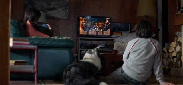 Daniel and Snoop sitting down and watching tv.