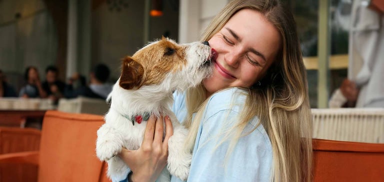 Puppy licking a woman's face