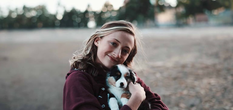 a woman hugging her puppy