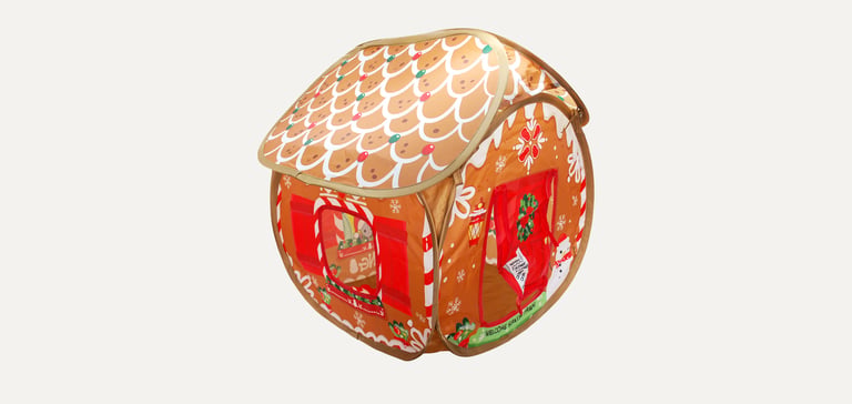 A promo image of a tent that looks like a gingerbread house.