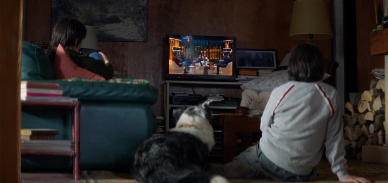 Daniel and Snoop sitting down and watching tv.