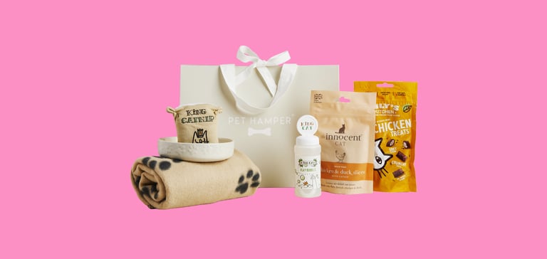 A pet gift hamper on a pink background.