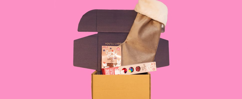 A stocking gift set on a pink background.
