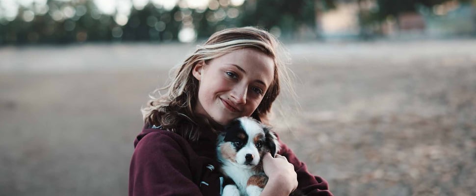 a woman hugging her puppy