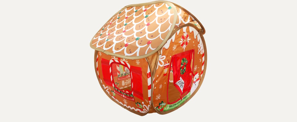 A promo image of a tent that looks like a gingerbread house.