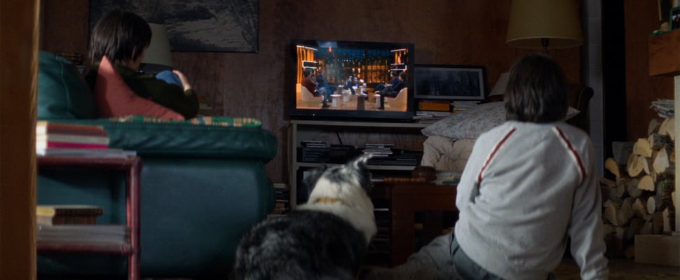 Daniel and Snoop sitting down and watching tv.